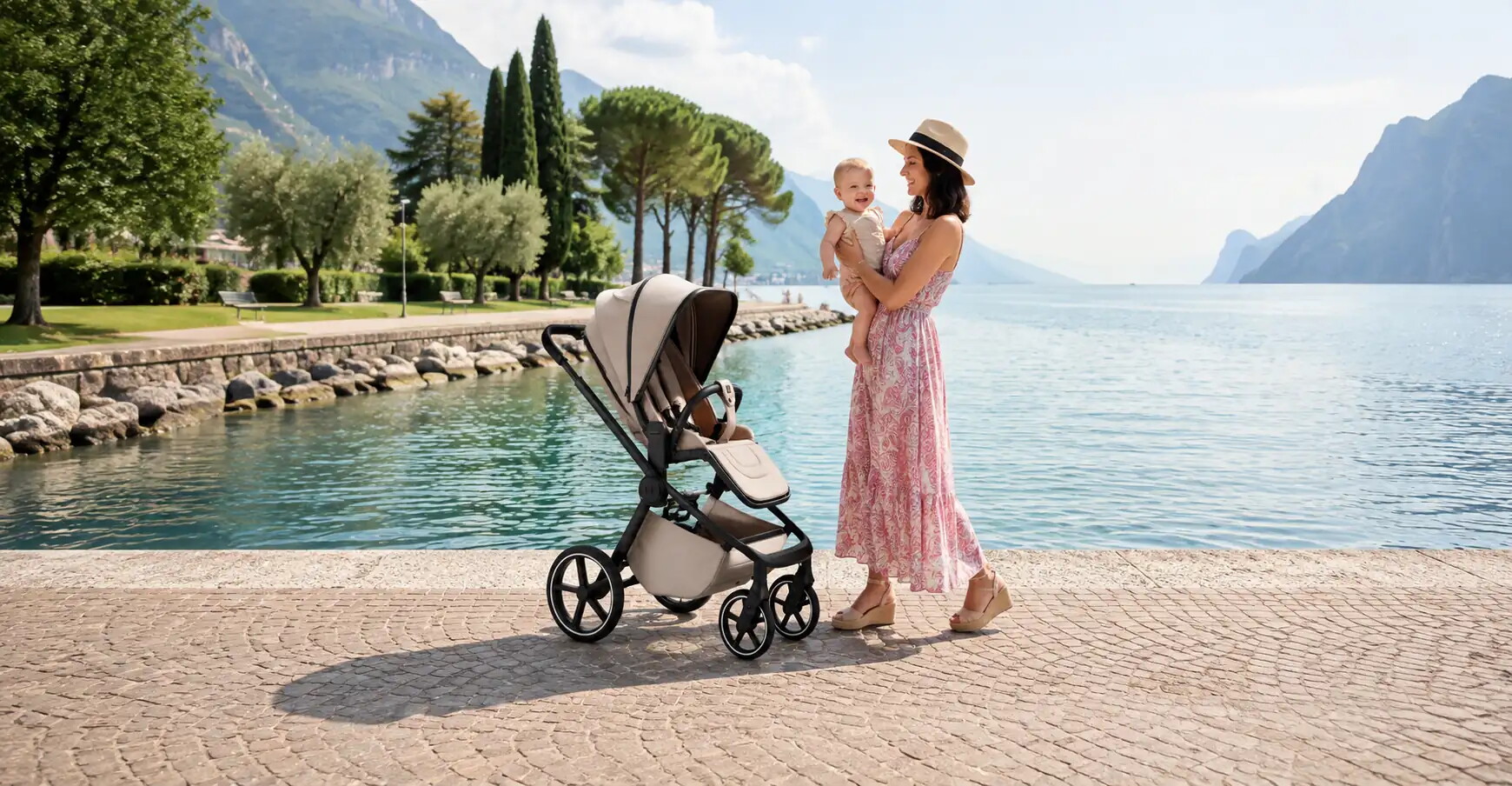 MOON HYPE buggy in sand on a lakeside promenade, next to a woman holding a baby