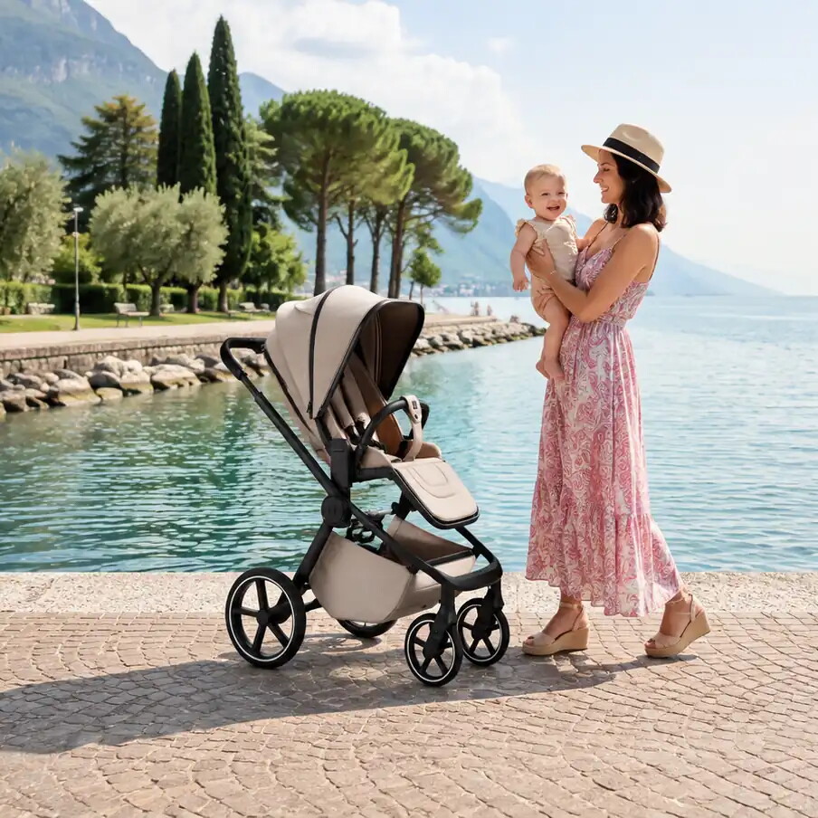 MOON HYPE buggy in sand on a lakeside promenade, next to a woman holding a baby